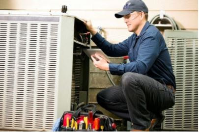 Commercial Contractor performing electrical diagnostic test on HVAC unit
