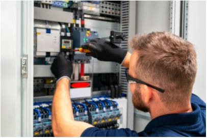 Electrician with black rubber glove working on control panel