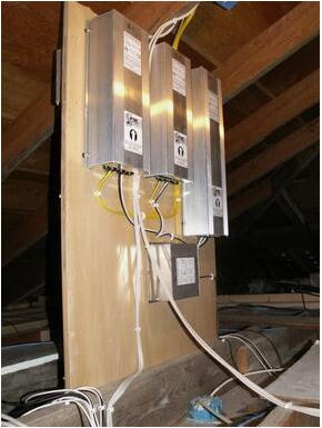 Multiple Electrical panels installed on wooden board inside attic